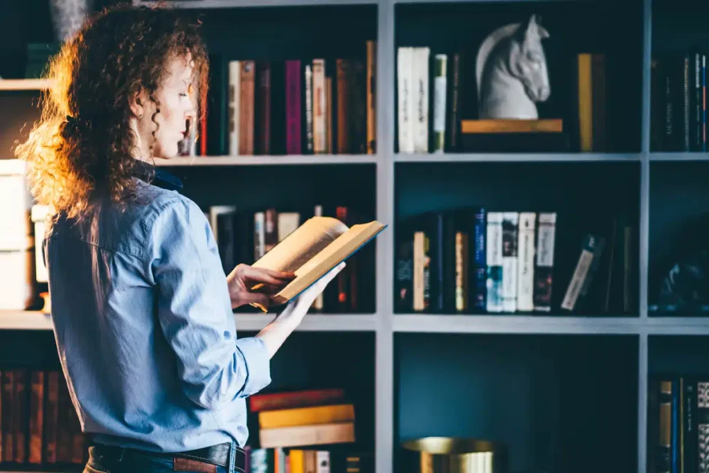 Woman choosing a book for ChatGPT inspiration to help shape personalized content