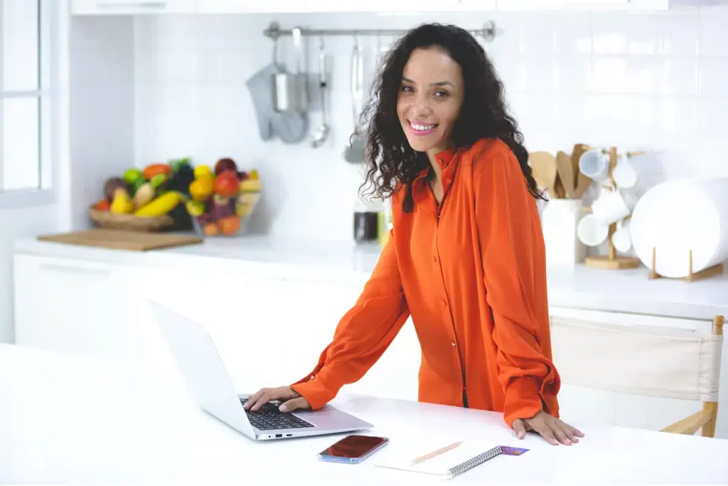 Dietitian writing a blog in her kitchen, illustrating how to make ChatGPT content reflect her own voice