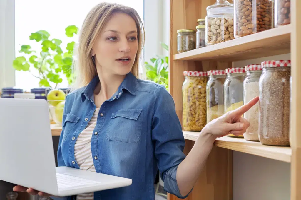 Dietitian on a video call pointing to a jar of grains during a client session
