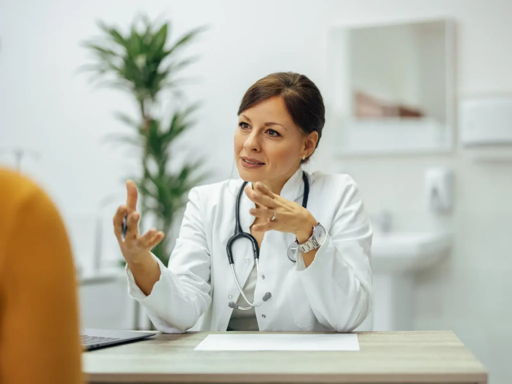 Healthcare practitioner explaining a concept during a one-on-one session, showing how expertise can be used to create educational marketing content