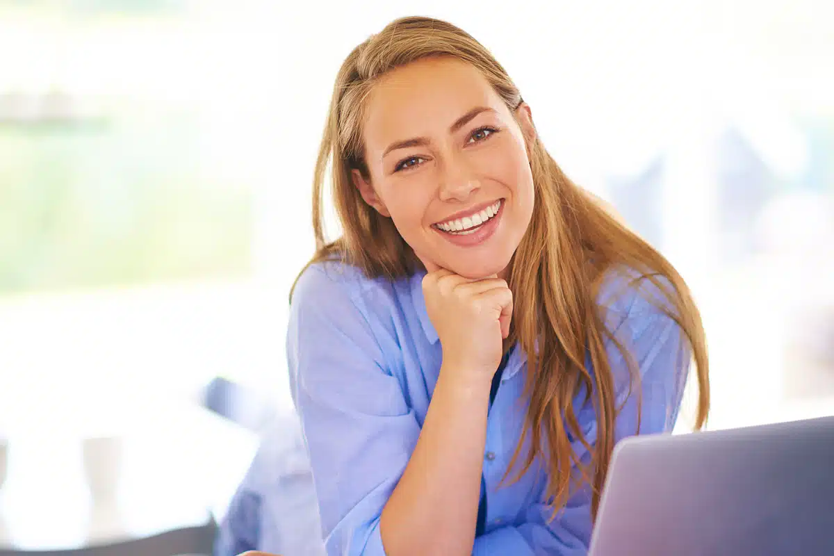 Woman smiling, representing a human approach to making ChatGPT reflect your personal voice