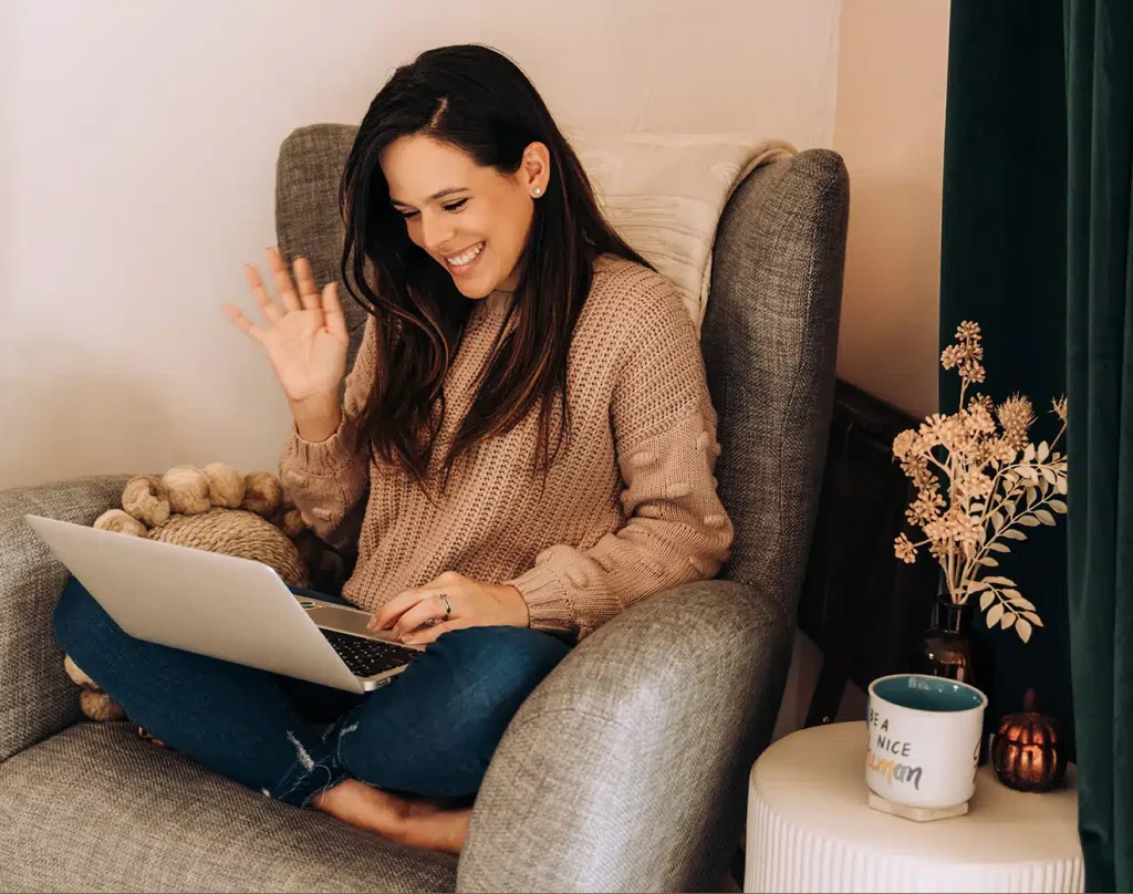 Woman speaking to her laptop while filming a live video