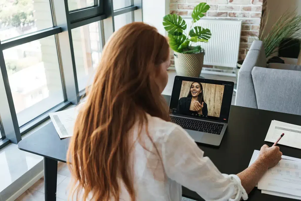 Woman on a video call with another woman, illustrating member engagement and retention in a program