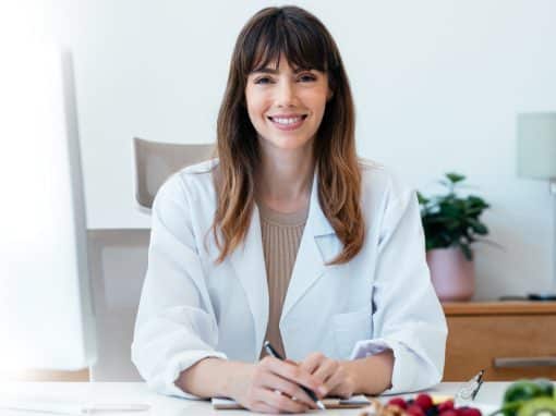 Dietitian holding a clipboard while applying the PES Statement in private practice nutrition care