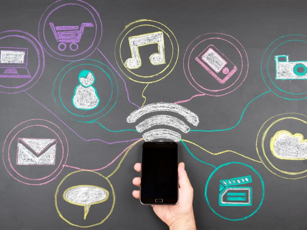 Smartphone surrounded by icons for email, video, social media, and messaging, showing how repurposing content works across platforms