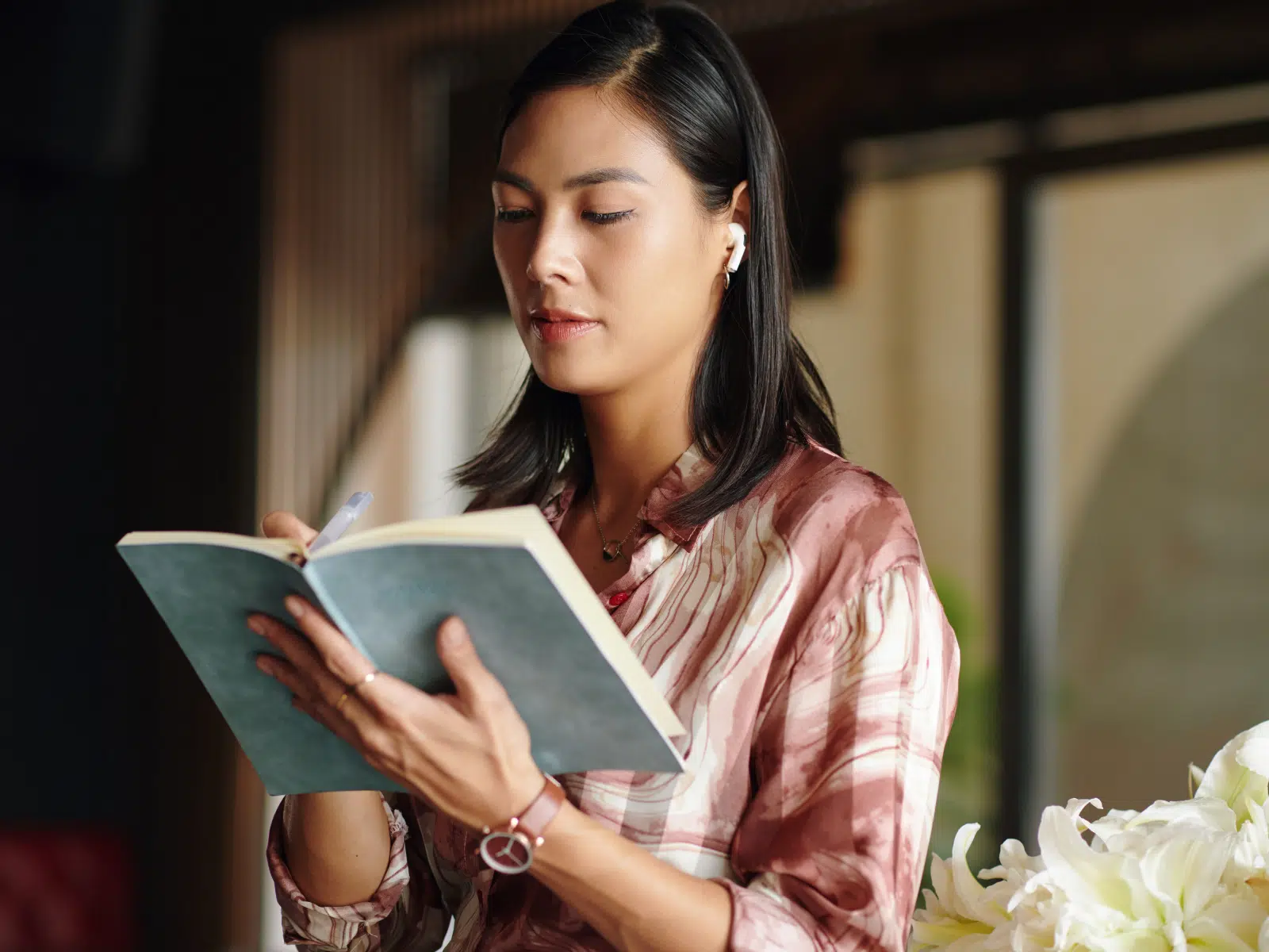 Woman writing in a notebook, representing a thoughtful and sustainable approach to repurposing content
